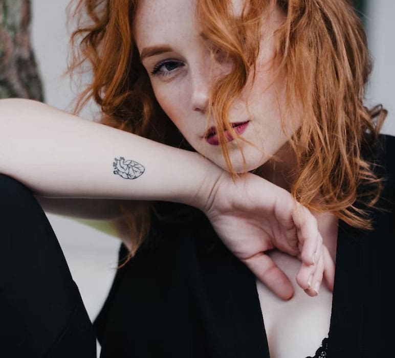 Woman with a Tattoo on her Arm Woman with a Tattoo on her Arm